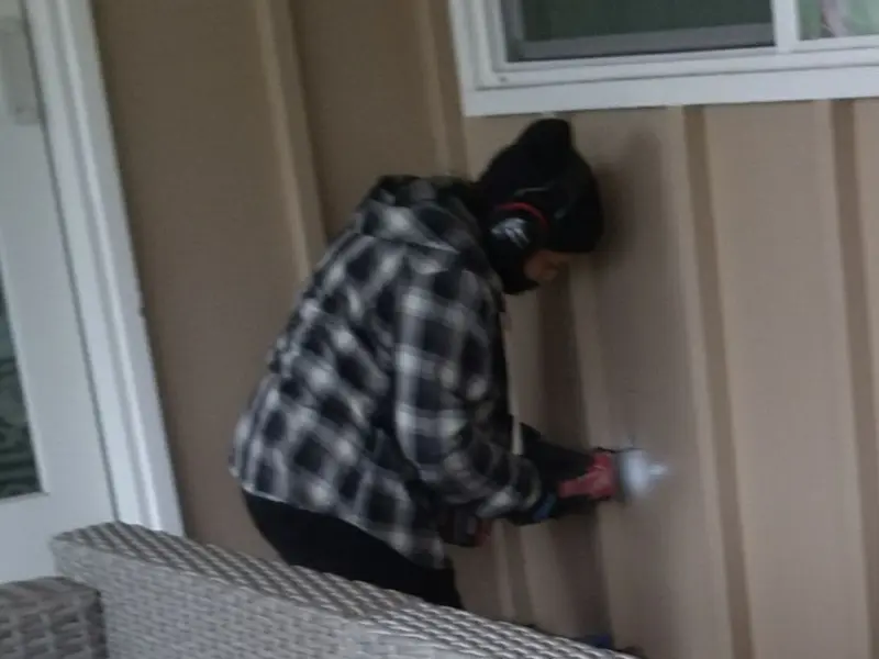 Professional electrician installing an exterior outlet in Sienna